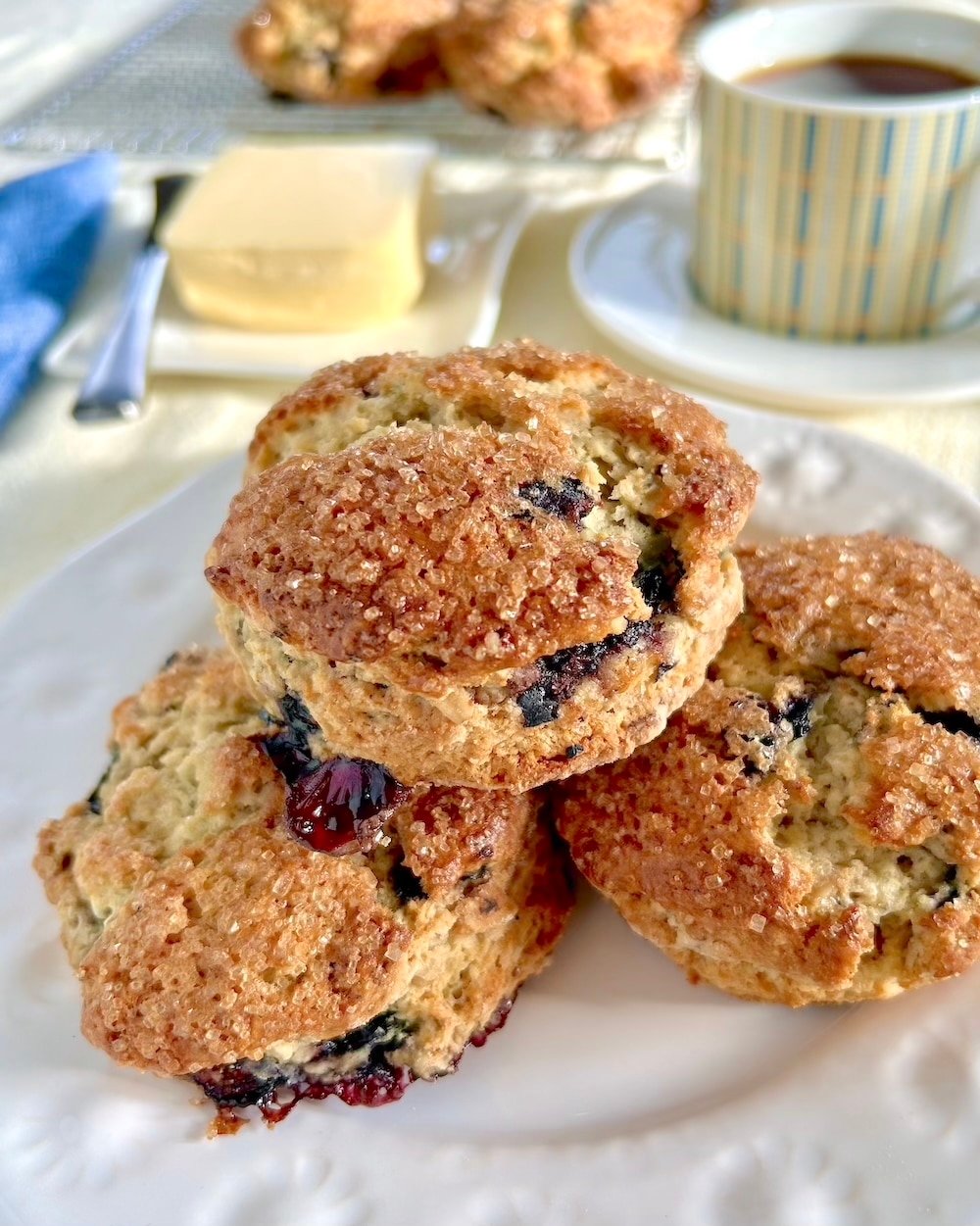 Blueberry Oatmeal Scones stacked on white plate for Instagram