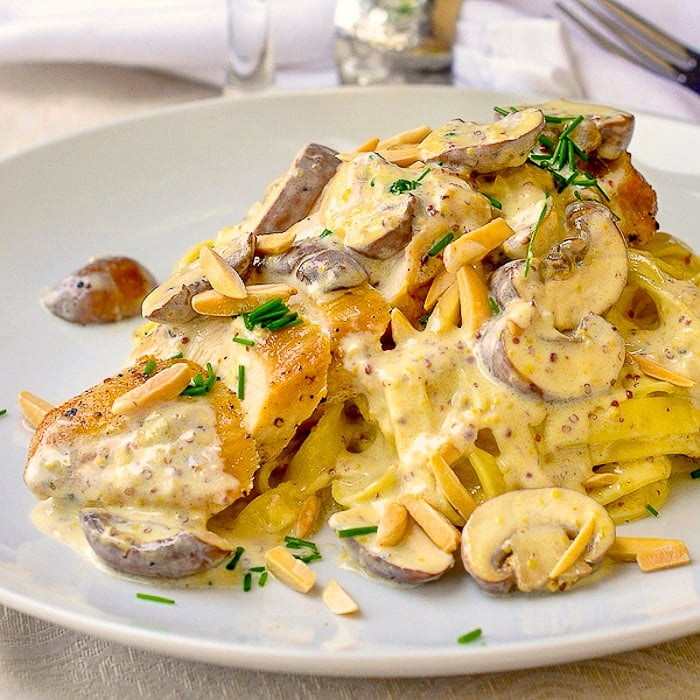 Creamy Dijon Chicken Linguine close up phot of single serving on a white plate