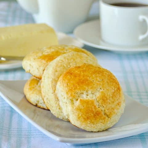 Coconut Tea Buns on a white plate with coffee service in the background