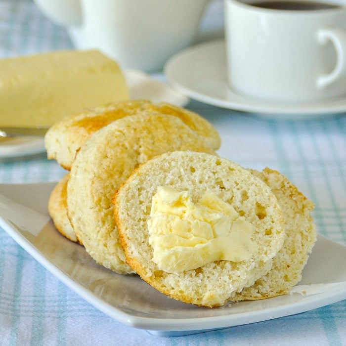 Coconut Tea Buns photo of butter spread on a tea bun cut in half