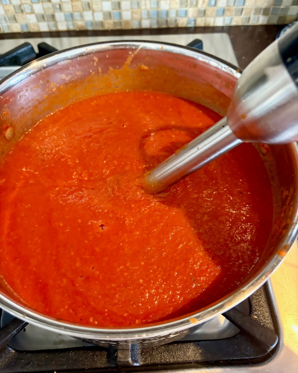 Photo of immersion blender in the sauce.