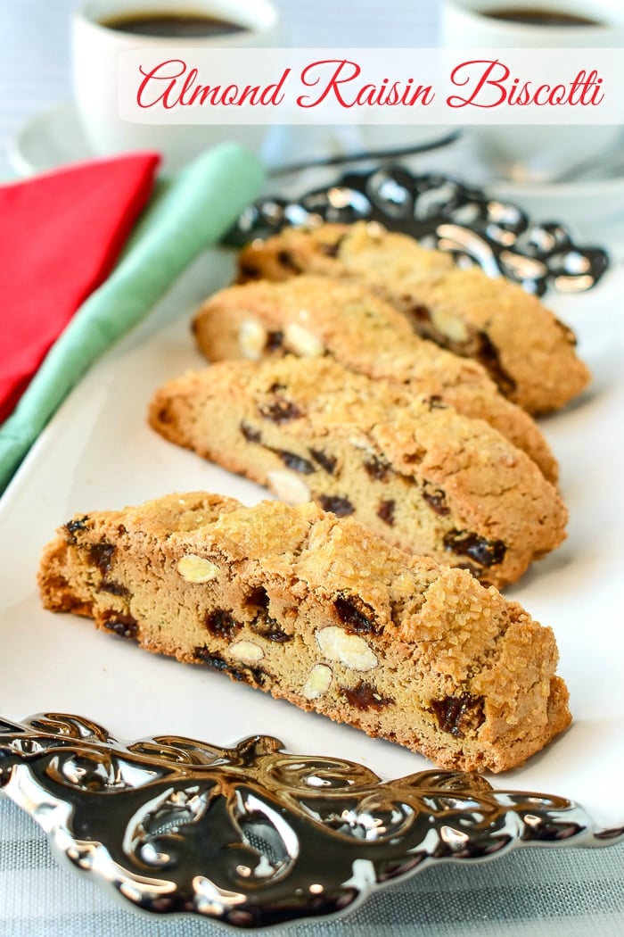 Almond Raisin Biscotti shown served on a white and silver platter with title text added for Pinterest