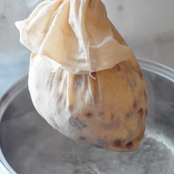 Newfoundland Figgy Duff beoing lowered into a pot of boiling water