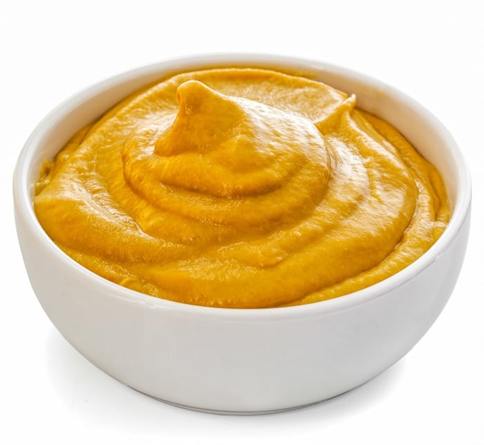 Dijon mustard in a white bowl