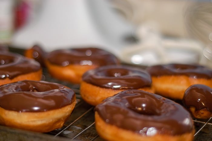 Homemade donuts after being chocolate glazed.