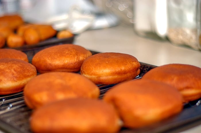 Homemade round donuts fried and waiting to be filled.