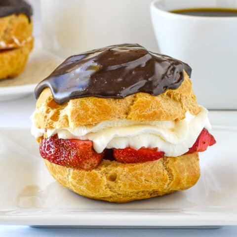 Strawberry Chocolate Custard Cream Puffs close up featured image of a single cream puff