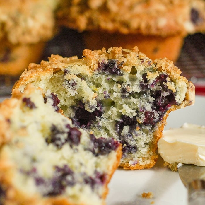 Lemon Blueberry Muffins with oatmeal almond streusel cut in half to show interior crumb structure