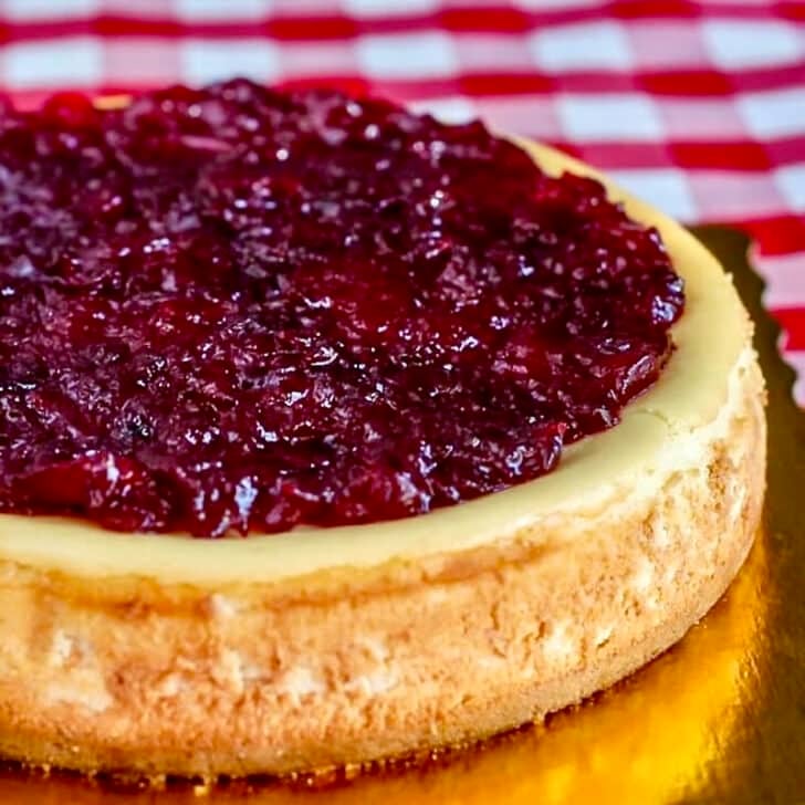 Partridgeberry Apple Cheesecake photo of completed cheesecake on a gold coloured board.