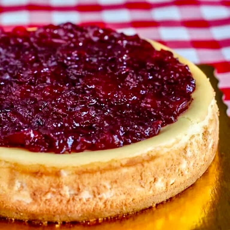 Partridgeberry Apple Cheesecake photo of completed cheesecake on a gold coloured board.