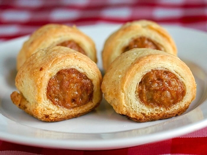 Sour Cream Pastry Sausage Rolls photo on a white plate.