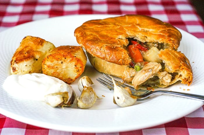 Turkey Pot Pie broken open to show veggies, gravy and turkey inside