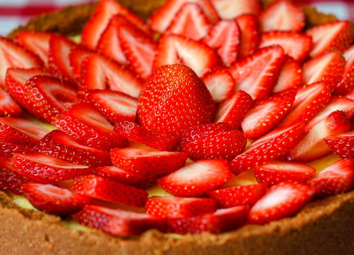 Strawberry Cointreau Sour Cream Custard Flan close up shot of completed flan garnished with strawberries