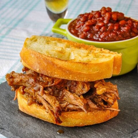 Apple Barbecue Pulled Pork Sandwich shown with homemade baked beans