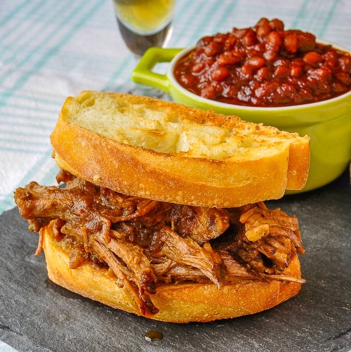 Apple Barbecue Pulled Pork Sandwich shown with homemade baked beans