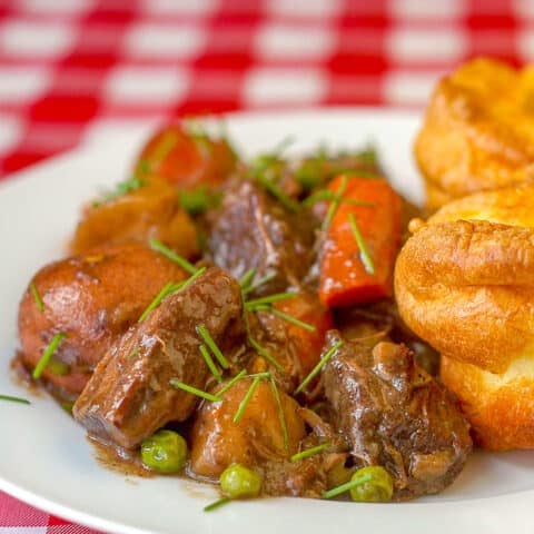 Burgundy Beef Stew close up photo of a serving on white plate