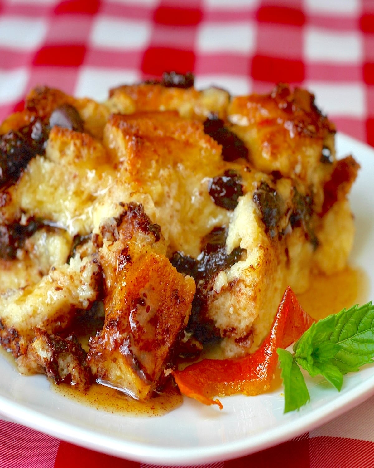 Chocolate Orange Bread pudding with a red checker tablecloth in background.