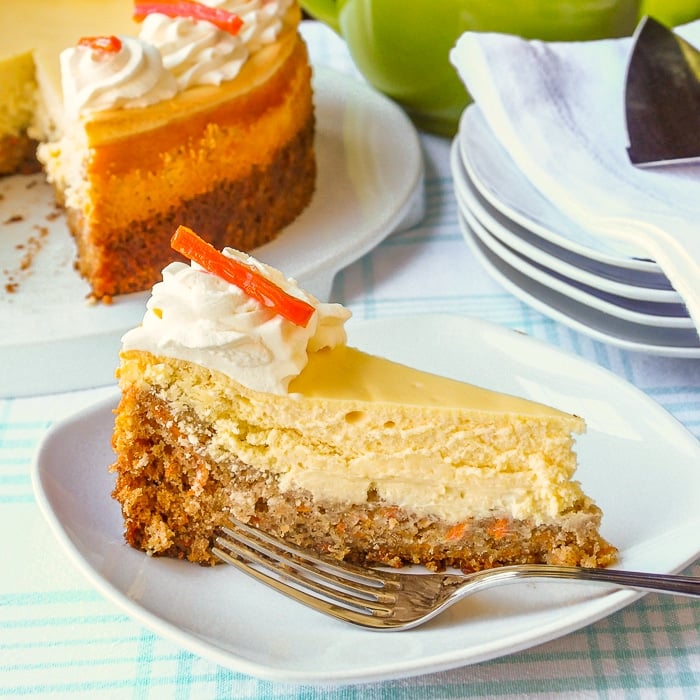 Carrot Cake Cheesecake photo of a single slice on a white plate