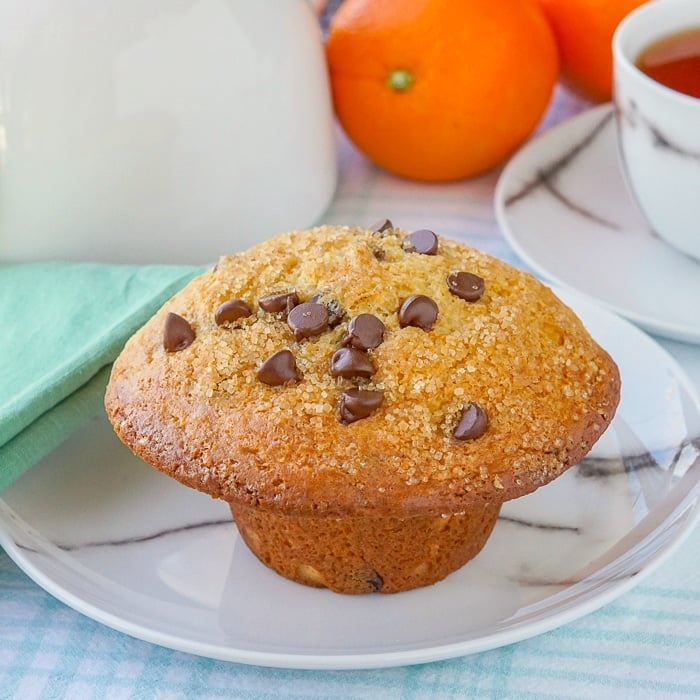 Chocolate Orange Muffins featured image close up of one muffin on a marble pattern plate