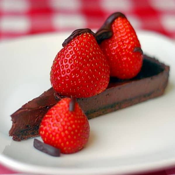 Strawberry Chocolate Truffle Tart photo of a single slice on a white plate