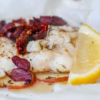 Newfoundland Cod with Olives and Sundried Tomatoes en Papillote showing open parchment paper packet