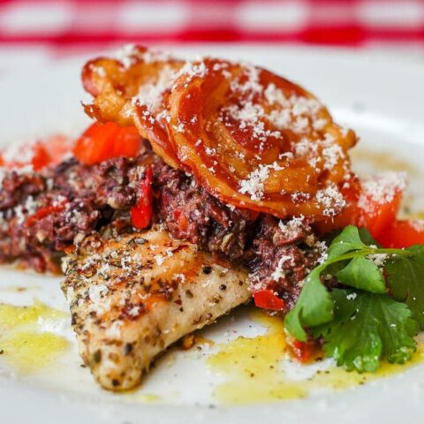 Garlic Oregano Chicken with Red Pepper Parmesan Tapenade and Crispy Pancetta, close up photo