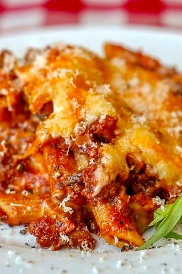 Easy Italian Sausage Baked Penne close up image of a single serving on a white plate.