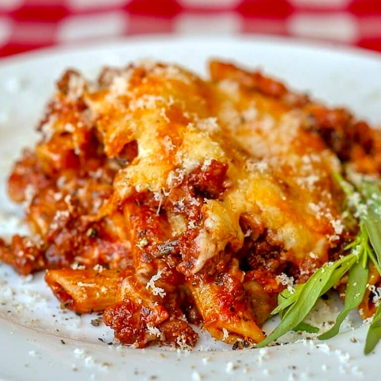 Easy Italian Sausage Baked Penne close up image of a single serving on a white plate.