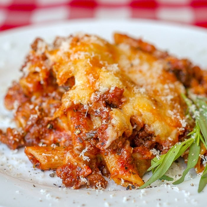 Easy Italian Sausage Baked Penne close up image of a single serving on a white plate