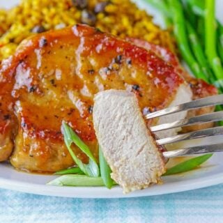 Honey Ginger Dijon Glazed Pork Chops photo od cut pork chop showing fully cooked inside.