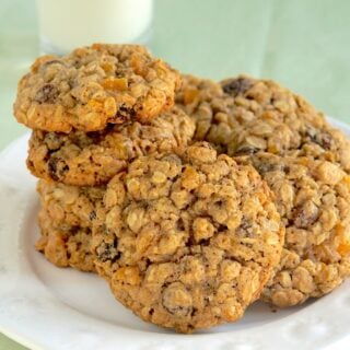 Apricot Raisin Five Spice Oatmeal Cookies stacked on a white plate