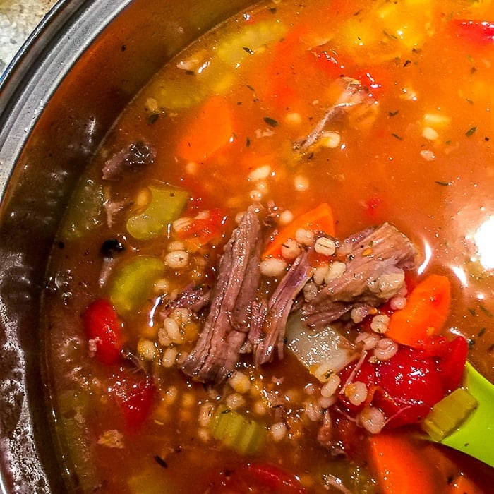 Beef Barley Soup photo of soup simmering in a pot