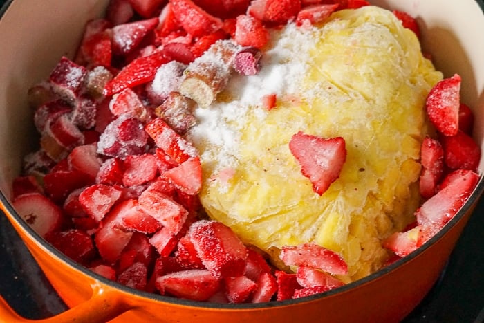 Heavenly Rhubarb Jam ingredients in a n enameled pot