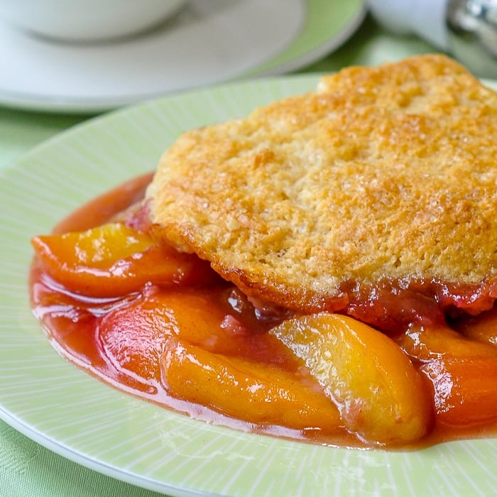 Peach Cobbler close up image of a single serving on green plate