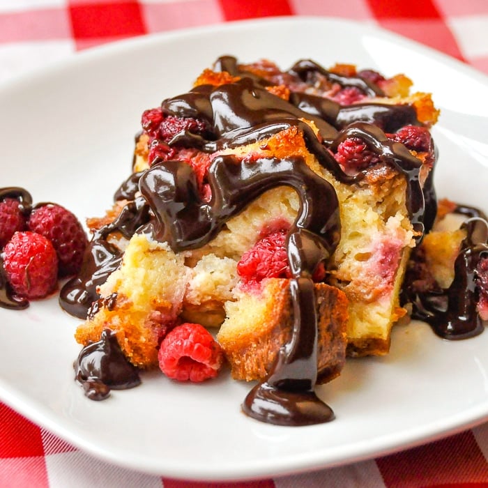 Raspberry Chocolate Bread Pudding square cropped featured image of a single serving on a white plate
