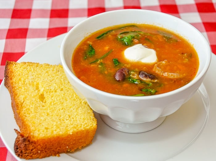 Sausage Chili Soup with a slice of cornbread on the side
