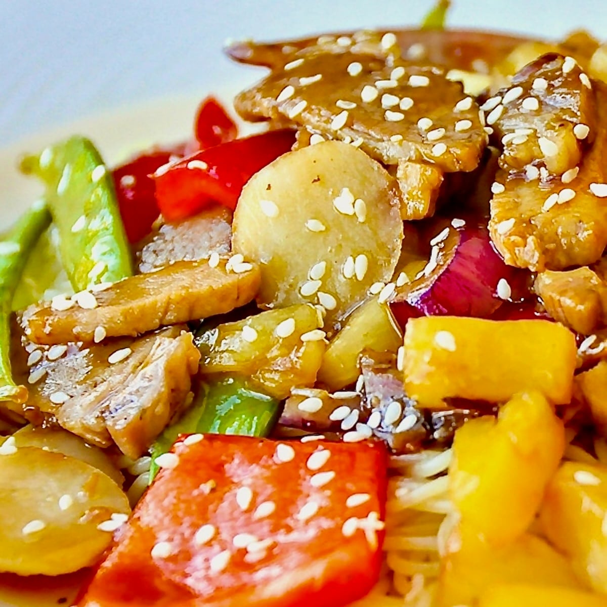 close up pohoto. Easy Stir Fried Pineapple Pork featured square image on white plate served with noodles