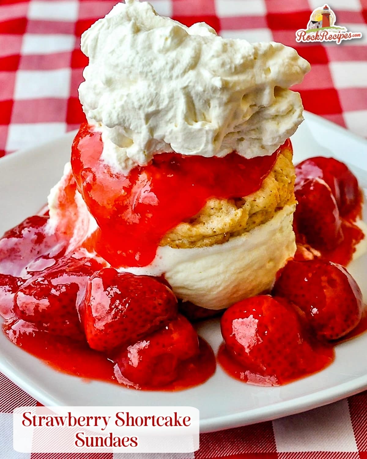 Strawberry Shortcake Sundaes close up photo of one serving on a white square plate with title text added for social media posts.