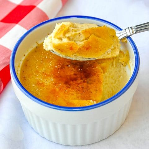 Eggnog Creme Brulée showing spoon filled with the dessert