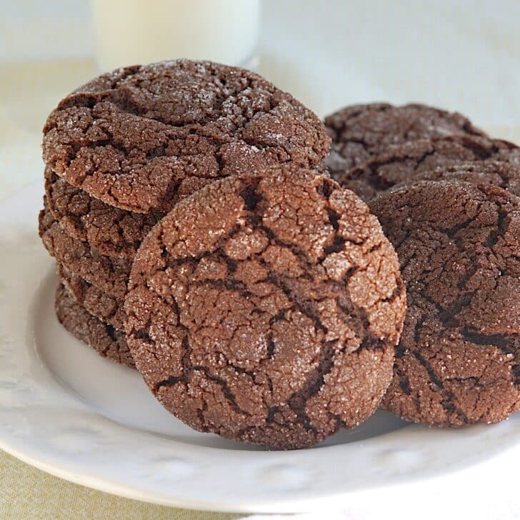 Espresso Chocolate Chip Cookies stacked on a white plate