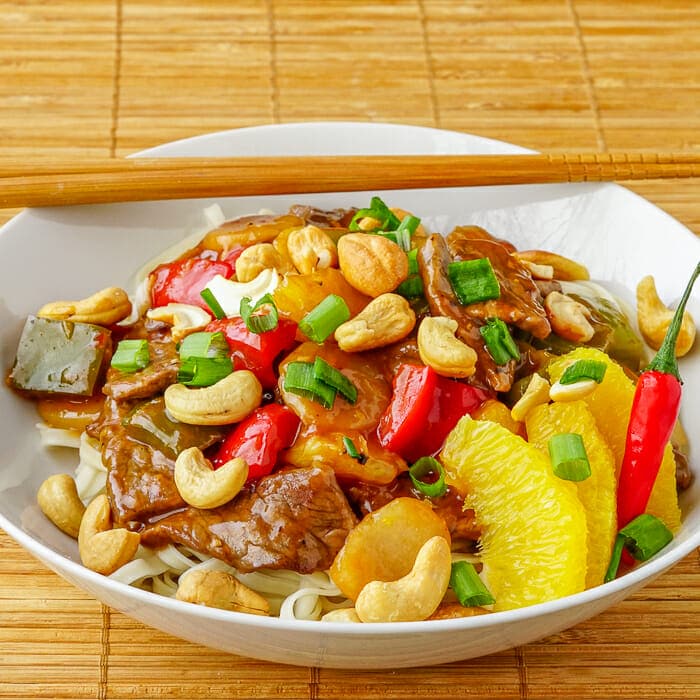 Orange Beef with Cashews close up image in bowl.