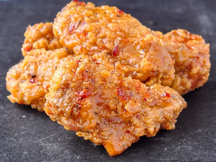 Crispy Sweet Spicy Sticky Wings shown on a slate serving platter