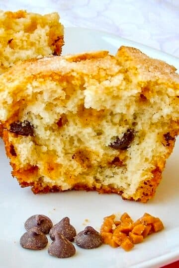 Toffee Chocolate Chip Muffins photo of one muffin split open on a white plate