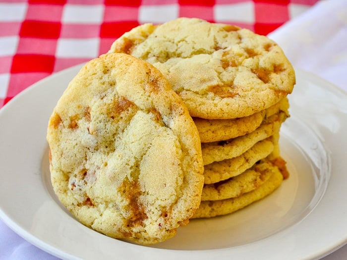 Toffee Pecan Cookies stacked on a white plate