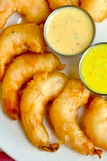 Beer Battered Shrimp photo of a platter of shrimp organized on a semi circle on a white platter, close up ohoto for Google featured image.