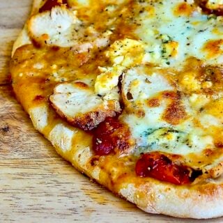 Buffalo Wing Pizza close up photo on a wooden cutting board