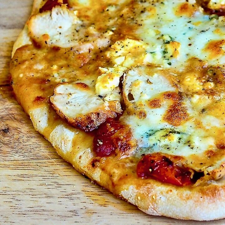 Buffalo Wing Pizza close up photo on a wooden cutting board