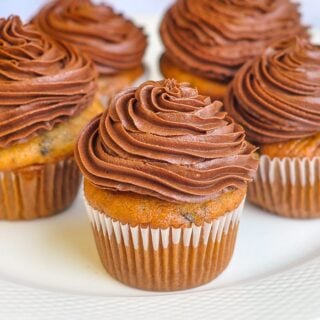 Double Chocolate Banana Cupcakes close up photo of one cupcake with others in background.