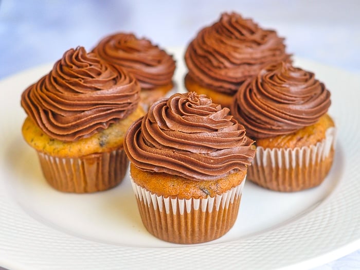 Double Chocolate Banana Cupcakes photo of five cupcakes on a white plate.