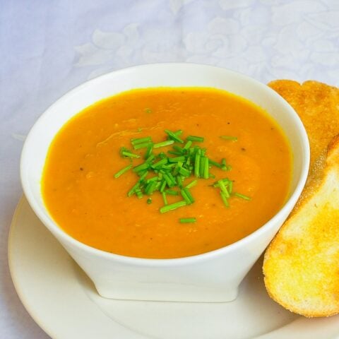 Roasted Carrot Celeriac Soup square cropped close up photo of soup in a white bowl